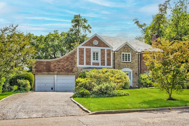 view of front of property with a garage and a front lawn