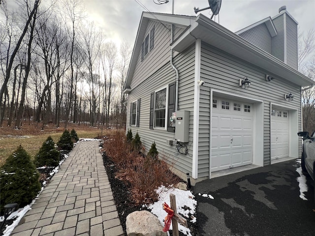 view of side of home with a garage