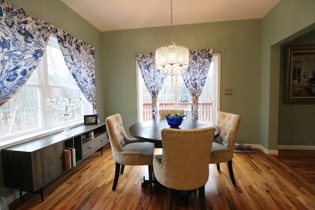 dining room with an inviting chandelier and light hardwood / wood-style flooring