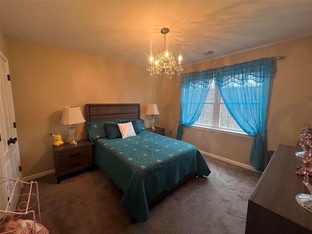 carpeted bedroom featuring an inviting chandelier