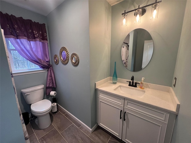 bathroom featuring toilet, tile patterned floors, and vanity