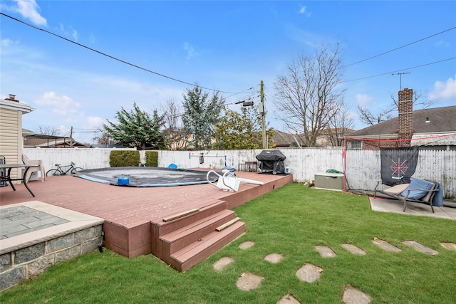 view of yard with a pool side deck