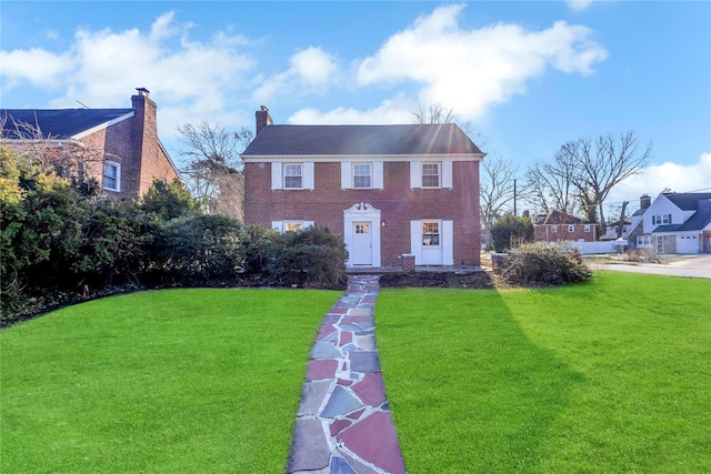 colonial-style house with a front yard