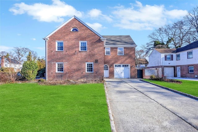 view of front of home featuring a front yard and a garage