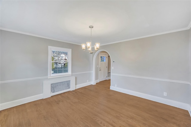 unfurnished dining area featuring hardwood / wood-style flooring, radiator heating unit, and crown molding