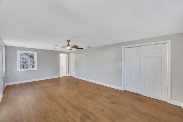 spare room with hardwood / wood-style flooring and ceiling fan