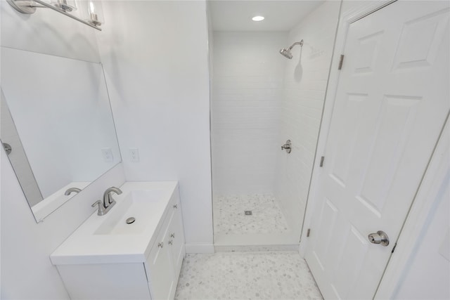 bathroom with vanity and tiled shower