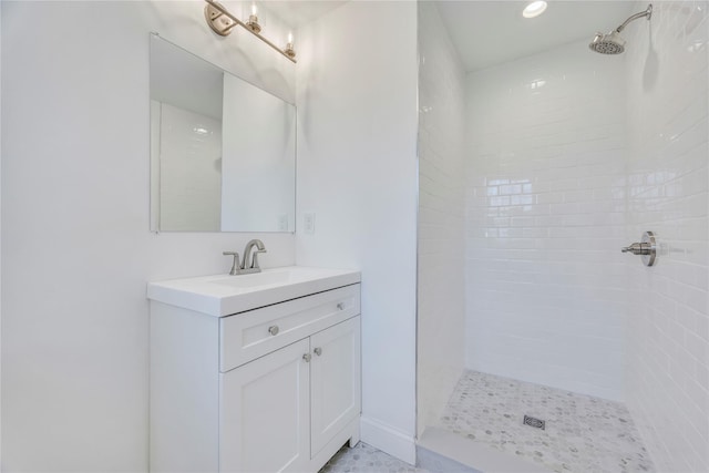 bathroom with vanity and tiled shower