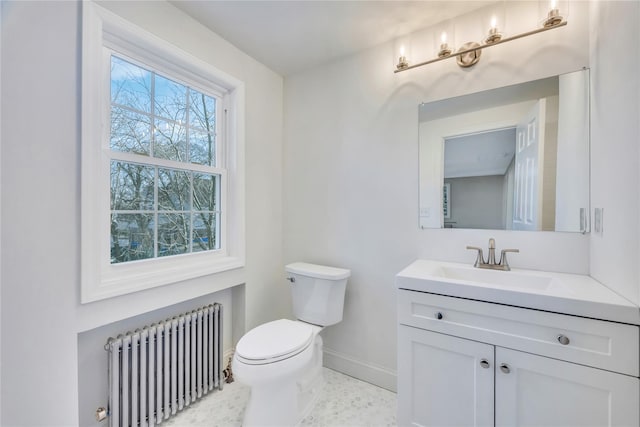 bathroom with vanity, toilet, and radiator heating unit