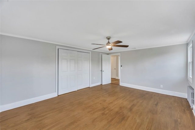 unfurnished bedroom with ceiling fan, crown molding, and wood-type flooring