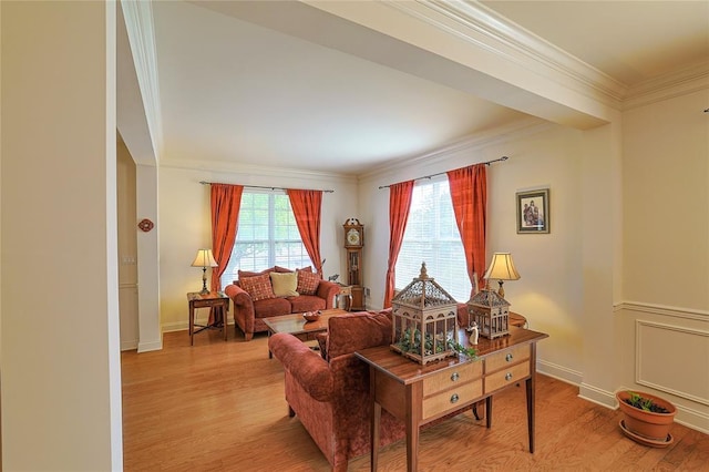 living room with light wood-type flooring and crown molding