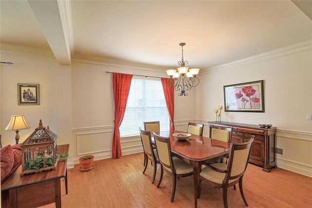 dining room featuring beamed ceiling, ornamental molding, light hardwood / wood-style floors, and a notable chandelier