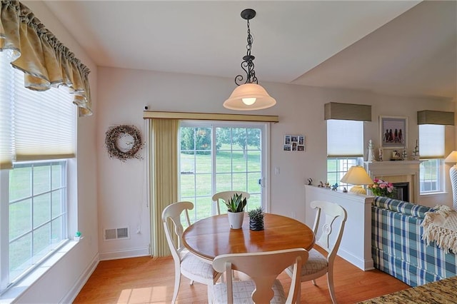 dining area with light hardwood / wood-style floors and a wealth of natural light