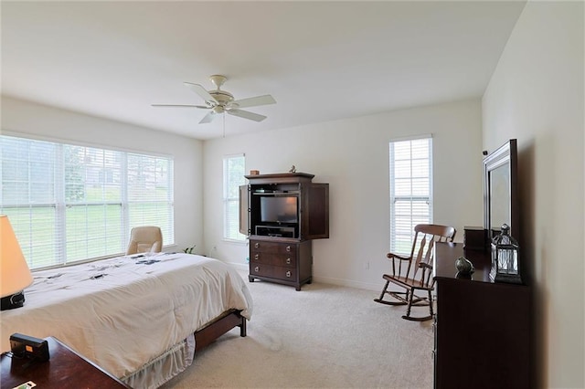 bedroom with ceiling fan and light carpet