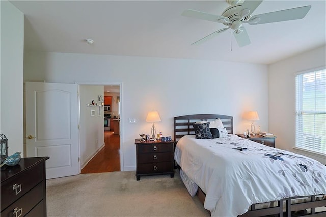 carpeted bedroom featuring ceiling fan