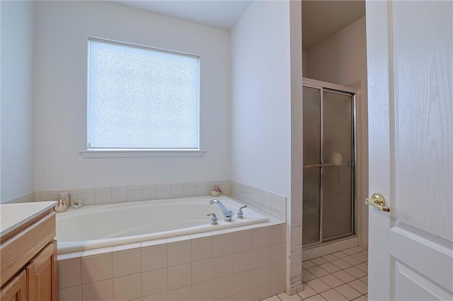 bathroom with vanity, tile patterned floors, plenty of natural light, and independent shower and bath