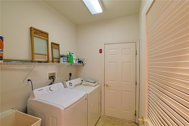 laundry room featuring washing machine and clothes dryer and sink