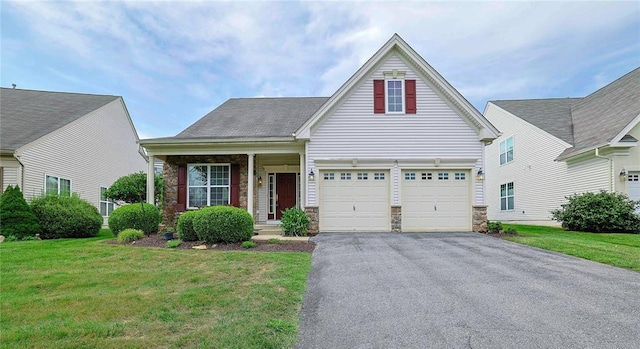 view of front of house featuring a front lawn and a garage