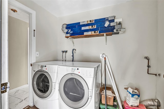 laundry room with laundry area, marble finish floor, and washing machine and clothes dryer