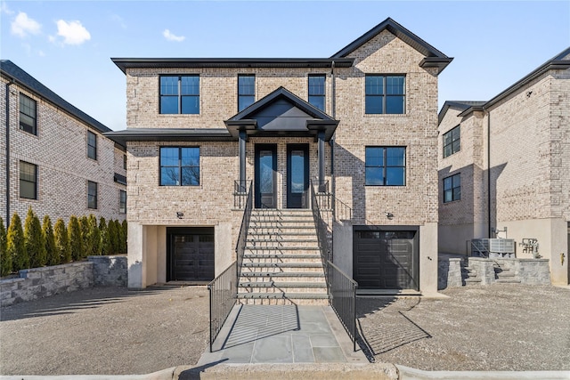 view of front facade with central AC unit and a garage