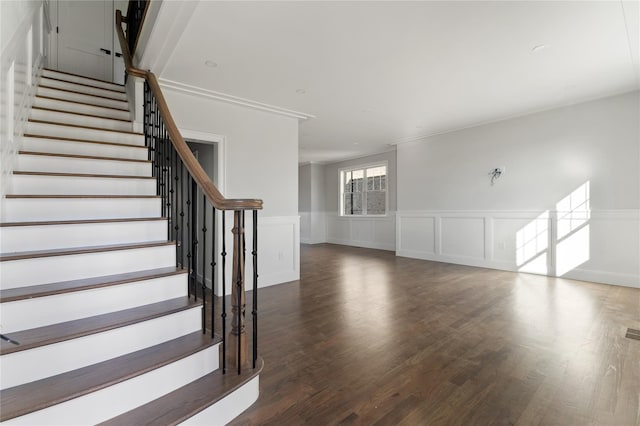 interior space featuring dark hardwood / wood-style flooring and ornamental molding