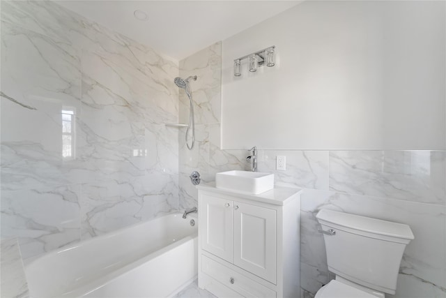 full bathroom featuring vanity, toilet, tile walls, and tiled shower / bath combo