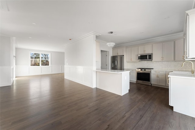 kitchen featuring crown molding, sink, hanging light fixtures, and appliances with stainless steel finishes