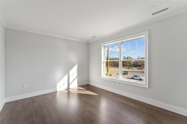 spare room featuring dark hardwood / wood-style floors and ornamental molding