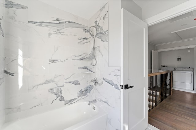 bathroom with hardwood / wood-style floors, independent washer and dryer, shower / washtub combination, and ornamental molding