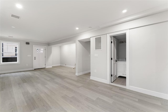 interior space featuring light hardwood / wood-style flooring and crown molding