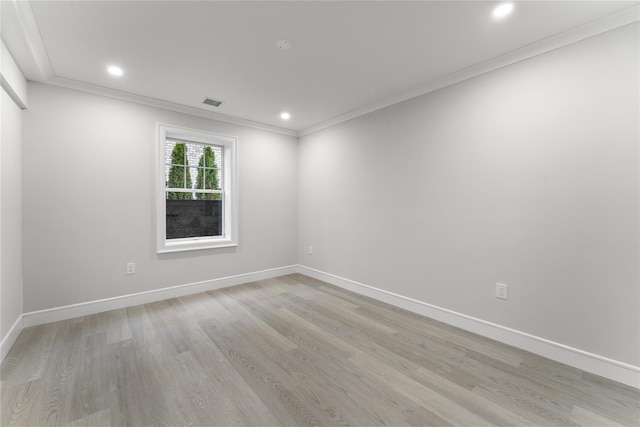 unfurnished room with light wood-type flooring and ornamental molding