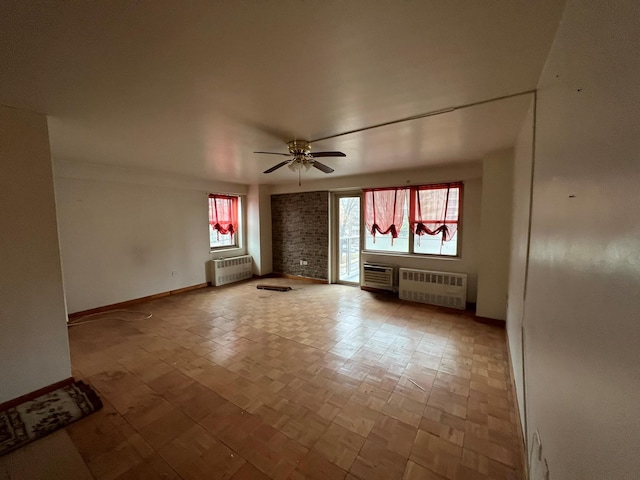 unfurnished living room with radiator and ceiling fan