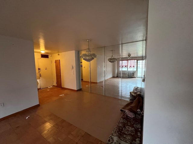 unfurnished room featuring a notable chandelier