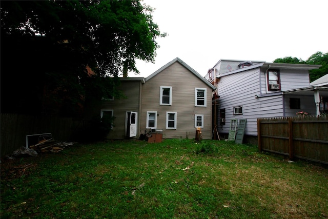 back of property featuring a yard