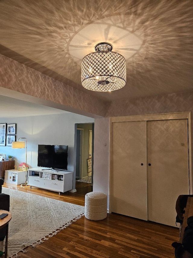 unfurnished living room with a chandelier and dark hardwood / wood-style floors