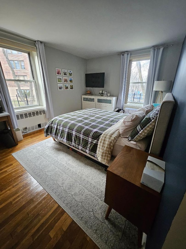 bedroom featuring wood-type flooring and radiator