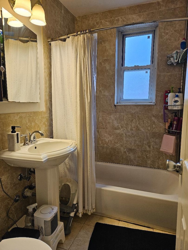 bathroom featuring backsplash, tile patterned floors, shower / tub combo with curtain, tile walls, and toilet