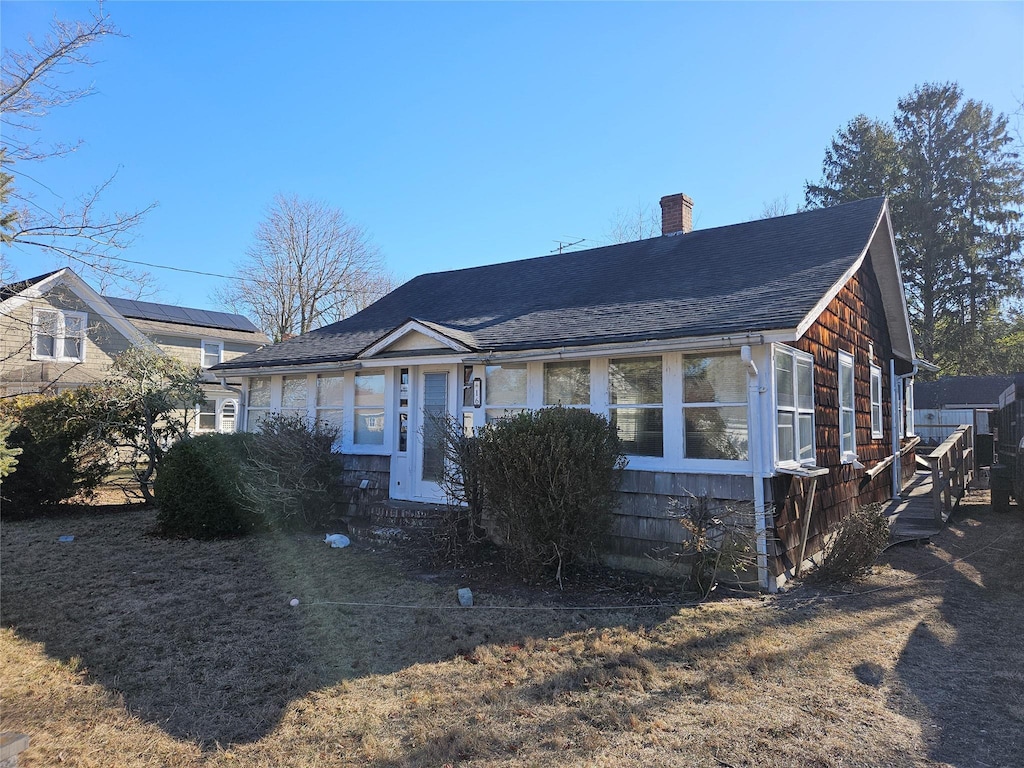 view of front of house featuring a sunroom