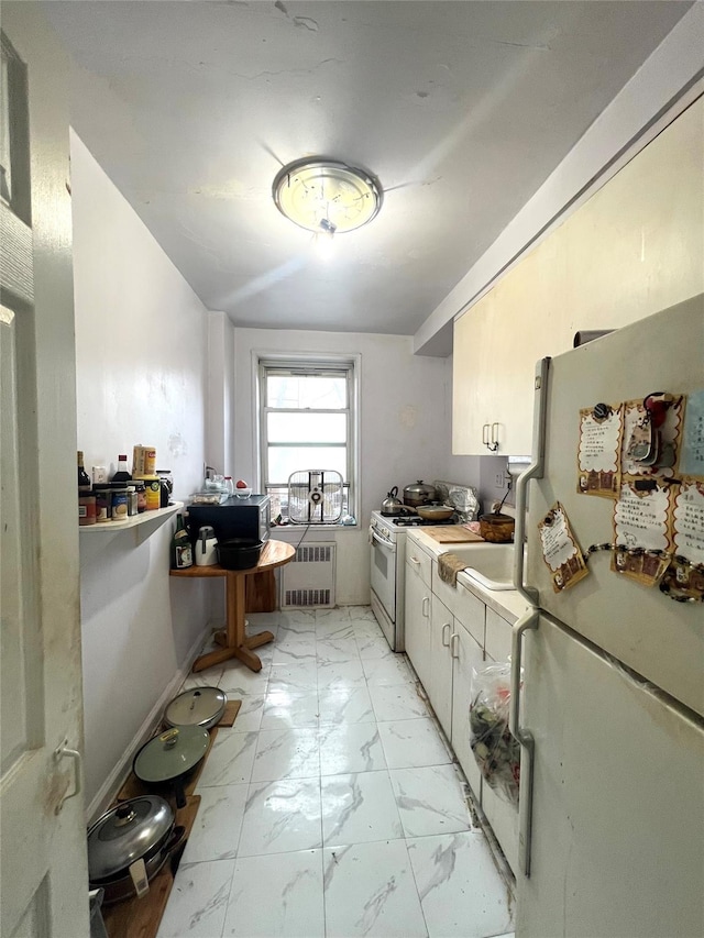 kitchen with white appliances and radiator