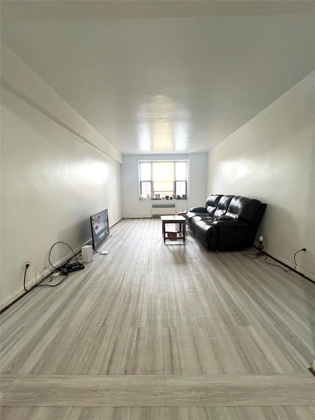 unfurnished living room with radiator and light hardwood / wood-style floors