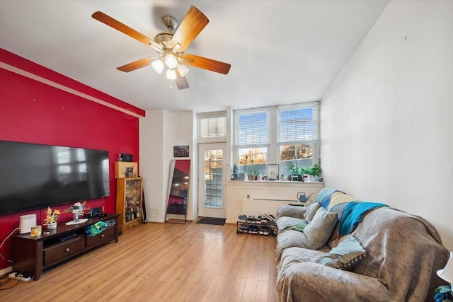 living room with ceiling fan and light hardwood / wood-style floors