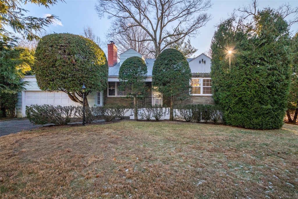 view of front of home with a front yard and a garage