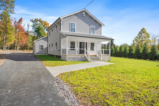 view of property with covered porch and a front lawn