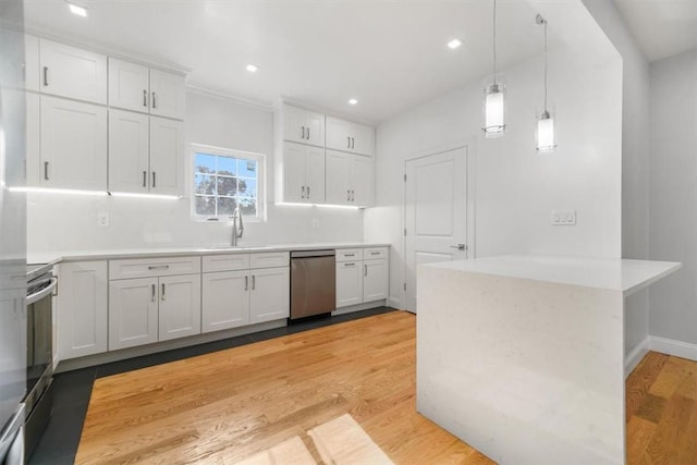 kitchen with kitchen peninsula, white cabinets, and stainless steel appliances