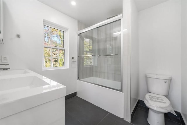 full bathroom with toilet, enclosed tub / shower combo, and vanity