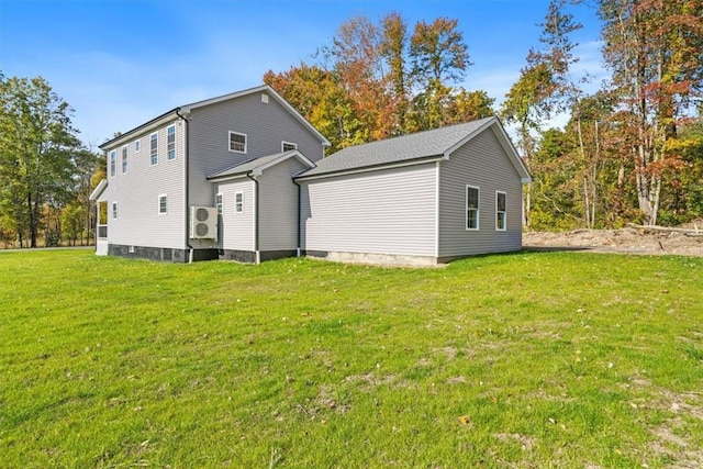 rear view of house featuring a yard