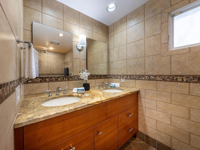 bathroom featuring tasteful backsplash, vanity, and tile walls