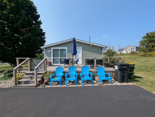 exterior space with a lawn and a wooden deck