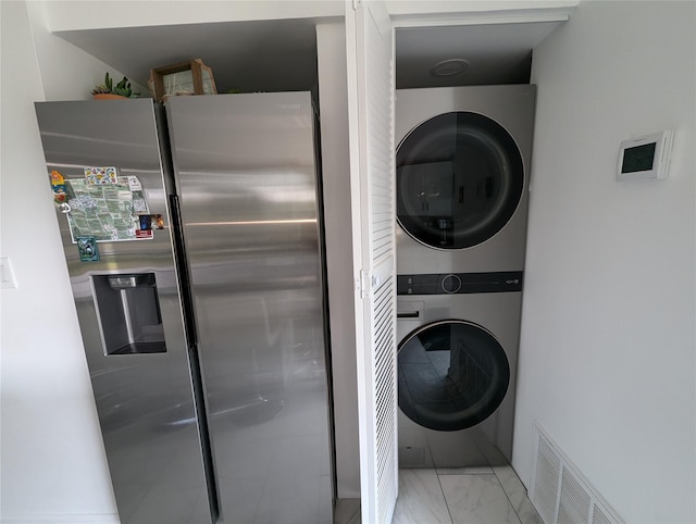 laundry room with stacked washer and clothes dryer