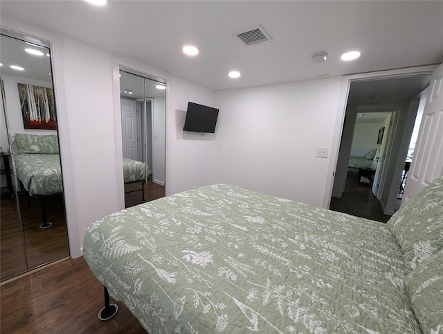 bedroom with a closet and dark hardwood / wood-style floors